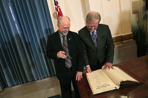 Newly inducted into the Order of the Buffalo Hunt, Music Historian and teacher John Einarson and Provincial Chief of Protocol Dwight MacAuley flip through the Order's Book of Honories looking up names like Chad Alen, Neil Young and Burton Cummings. Personalities Einarson taught and documented many times over his career. See release. January 8, 2016 - (Phil Hossack / Winnipeg Free Press)