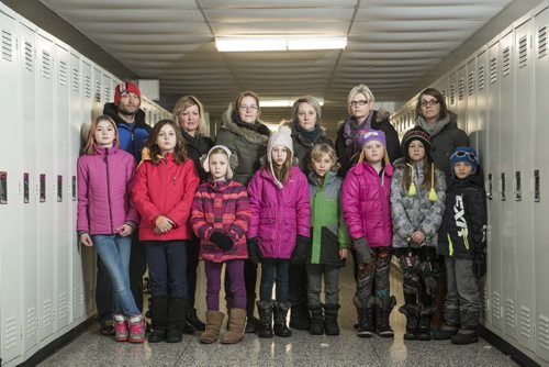 DAVID LIPNOWSKI / WINNIPEG FREE PRESS 160108  A group of parents and kids are upset with St. James-Assiniboia School Division's handling of a proposed French milieu school at Ness.  Front row (L-R): Hailee MacDonald, Shae and sister Rya Tovell-Millar, Ava and brother Ramsey Millar, Teagan McMahon, Vaughn and brother Boston Barnesky  Back row (L-R): Clint MacDonald , Nancy Tovell, Lisa Omand, Julie Millar, Marit Tollefsen, Quincy Barnesky