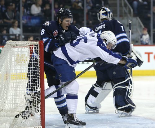 Manitoba Moose defenceman Brenden Kichton clears  Toronto Marlies LW Brett Findlay from the front of the net during American Hockey League action at the MTS Centre on Jan. 8, 2016. Photo by Jason Halstead/Winnipeg Free Press