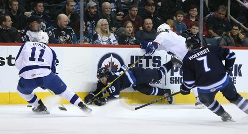 Manitoba Moose centre Chase De Leo falls as Toronto Marlies RW Zach Hyman picks up the puck during American Hockey League action at the MTS Centre on Jan. 8, 2016. Photo by Jason Halstead/Winnipeg Free Press