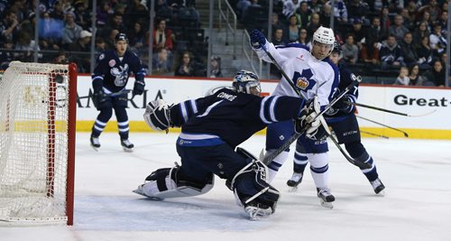 Manitoba Moose goalies Eric Comrie watches as a Toronto Marlies shot goes narrowly wide during American Hockey League action at the MTS Centre on Jan. 8, 2016. Photo by Jason Halstead/Winnipeg Free Press