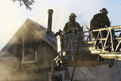 Firefighters continue to put out hotspots at a house that was completely destroyed by an early morning fire in the one hundred block of Cathedral Avenue.  160110 Sunday 10, 2016 Mike Deal / Winnipeg Free Press