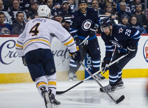 Winnipeg Jets' Blake Wheeler (26) looks for a shot on the net past Buffalo Sabres' Josh Gorges (4) during second period NHL action in Winnipeg on Sunday, January 10, 2016. 160110 - Sunday, January 10, 2016 -  MIKE DEAL / WINNIPEG FREE PRESS