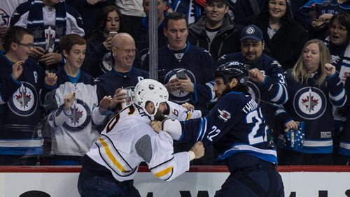 Winnipeg Jets' Chris Thorburn (22) and Buffalo Sabres' Mike Weber (6) fight during second period NHL action in Winnipeg on Sunday, January 10, 2016. 160110 - Sunday, January 10, 2016 -  MIKE DEAL / WINNIPEG FREE PRESS