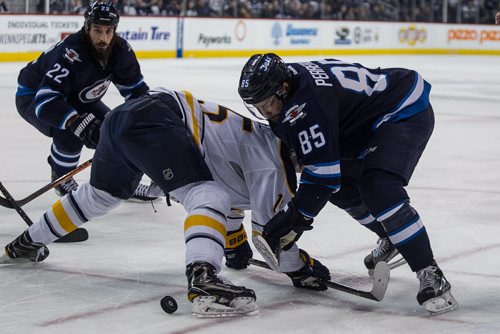 Winnipeg Jets' Mathieu Perreault (85) ties up Buffalo Sabres' Jack Eichel (15) during a face-off in the second period NHL action in Winnipeg on Sunday, January 10, 2016. 160110 - Sunday, January 10, 2016 -  MIKE DEAL / WINNIPEG FREE PRESS