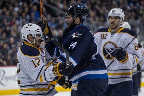 Winnipeg Jets' Anthony Peluso (14) and Buffalo Sabres' Brian Gionta (12) have words after the play during second period NHL action in Winnipeg on Sunday, January 10, 2016. 160110 - Sunday, January 10, 2016 -  MIKE DEAL / WINNIPEG FREE PRESS