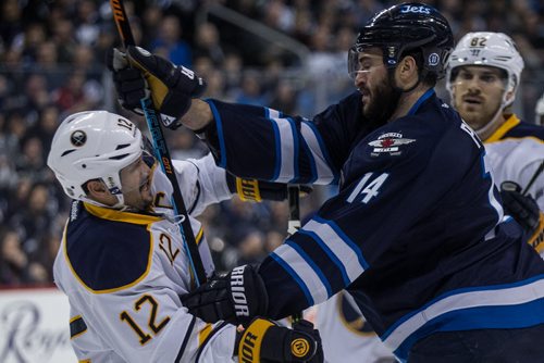 Winnipeg Jets' Anthony Peluso (14) and Buffalo Sabres' Brian Gionta (12) have words after the play during second period NHL action in Winnipeg on Sunday, January 10, 2016. 160110 - Sunday, January 10, 2016 -  MIKE DEAL / WINNIPEG FREE PRESS