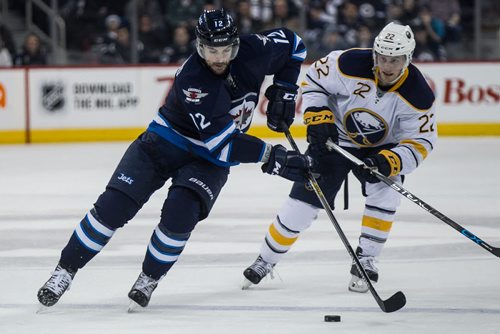 Winnipeg Jets' Drew Stafford (12) on the break-a-way past Buffalo Sabres' Johan Larsson (22) during second period NHL action in Winnipeg on Sunday, January 10, 2016. 160110 - Sunday, January 10, 2016 -  MIKE DEAL / WINNIPEG FREE PRESS
