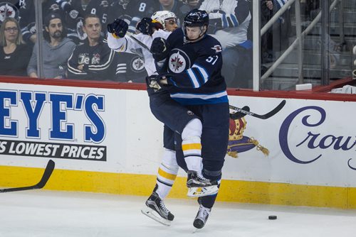 Winnipeg Jets' Tyler Myers (57) puts the stop to Buffalo Sabres' Evander Kane (9) during third period NHL action in Winnipeg on Sunday, January 10, 2016. 160110 - Sunday, January 10, 2016 -  MIKE DEAL / WINNIPEG FREE PRESS