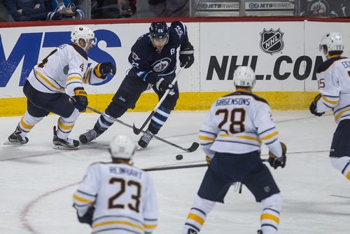 Winnipeg Jets' Blake Wheeler (26) is surrounded by Buffalo Sabres' Josh Gorges (4), Sam Reinhart (23), Zemgus Girgensons (28) and Jack Eichel (15) during third period NHL action in Winnipeg on Sunday, January 10, 2016. 160110 - Sunday, January 10, 2016 -  MIKE DEAL / WINNIPEG FREE PRESS