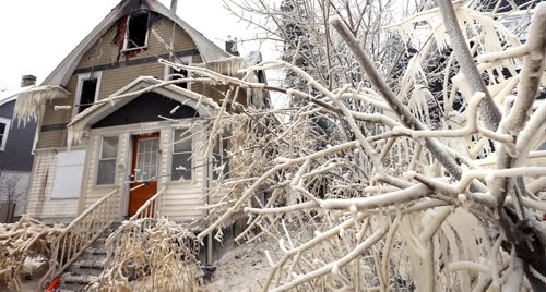 Ice covers tree branches and the home in the 100 block of Cathedral Avenue near St. Cross Street on a -22C Monday morning after a weekend fire. Police said there were many people in the home, but none were injured.Wayne Glowacki / Winnipeg Free Press Jan. 11 2016