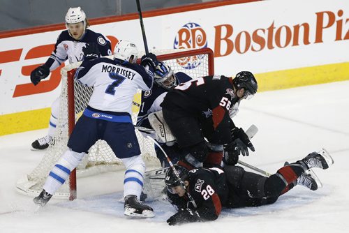 Manitoba Moose goaltender Eric Comrie (1) gets pushed into his net bt Lake Erie Monsters' Brett Gallant (56) and Lukas Sedlak (28) as Moose Ryan Olsen (9) and Josh Morrissey (7) defend during first period AHL action in Winnipeg on Monday, January 11, 2016. (John Woods / WINNIPEG FREE PRESS)
