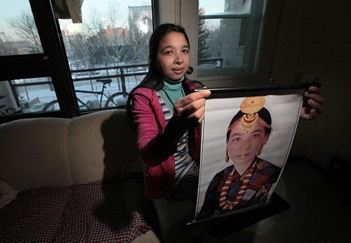 Sabitri Bhandari poses with a portrait of her wearing traditional Bhutanese costume and jewellry, taken just before she came to Canada The family came from Bhutan as refugees in the past year.   See Carol Sander's story. January 12, 2016 - (Phil Hossack / Winnipeg Free Press)