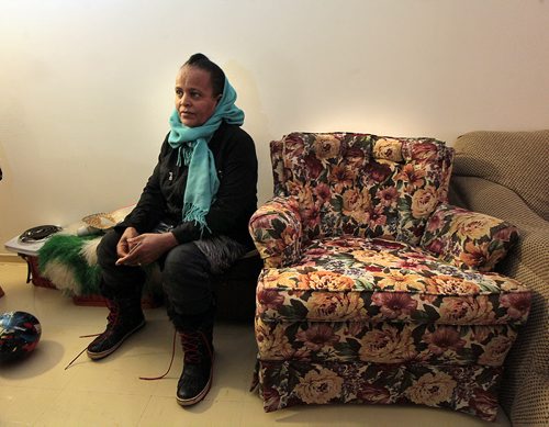Zewdi Habtmichael sits on a stool in her apartment, leaving the easy chair for the guest (me) as she talks to Carol. She and her 8 children came to Canada as refugees in the past year.  See Carol Sander's story. January 12, 2016 - (Phil Hossack / Winnipeg Free Press)