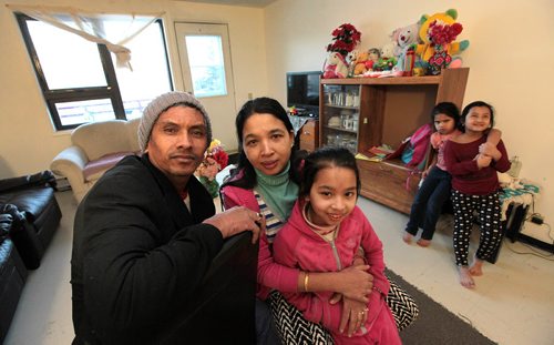 Tek and his wife Sabitri Bhandari pose with their daughter Neya (8). The family came from Bhutan as refugees in the past year. Two cousins who came seperately, Shreya (left) and Sahana (6) hover in the background.  See Carol Sander's story. January 12, 2016 - (Phil Hossack / Winnipeg Free Press)