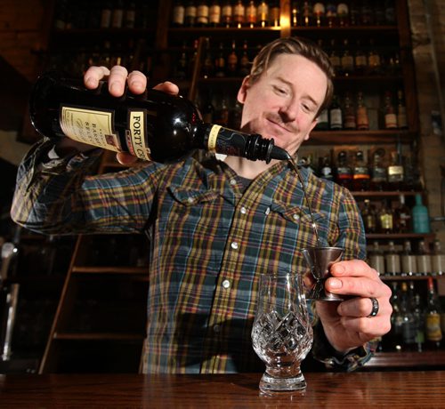 Tim Roth, Manager of the Toad in the Hole Pub on Osborne St. pours a shot of whiskey in the Whiskey Bar. Al Small story Wayne Glowacki / Winnipeg Free Press Jan. 13 2016