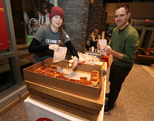 Mariah Baldwin of GenNext and Jason Granger of the United Way pack up cinnamon buns at the United Way Winnipeg Drive-Thru Boot Drive on Jan. 13, 2016 at United Way headquarters on Main Street. Donors who dropped off lightly-used children's boots were treated to free coffee and Jonnies Sticky Buns. The GenNext program, Koats For Kids and Grace Café were also involved in the event. Photo by Jason Halstead/Winnipeg Free Press RE: Social Page