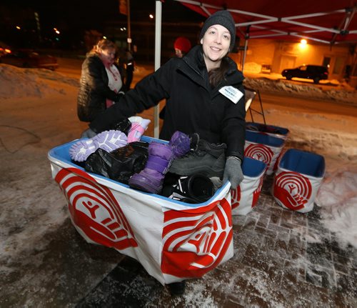 Meghan Ward of GenNext moves donated boots at the United Way Winnipeg Drive-Thru Boot Drive on Jan. 13, 2016 at United Way headquarters on Main Street. Donors who dropped off lightly-used children's boots were treated to free coffee and Jonnies Sticky Buns. The GenNext program, Koats For Kids and Grace Café were also involved in the event. Photo by Jason Halstead/Winnipeg Free Press RE: Social Page