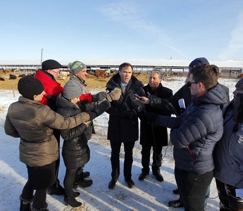 Minister of Finance Bill Morneau in Dugald, MB visiting a cattle farm. It's part of a Pre-Budget Consultations from coast to coast. He visited Calvin Vaag's cattle farm in frigid -20c temps. Here he is swarmed by journalists at the farm. BORIS MINKEVICH / WINNIPEG FREE PRESS January 14, 2016