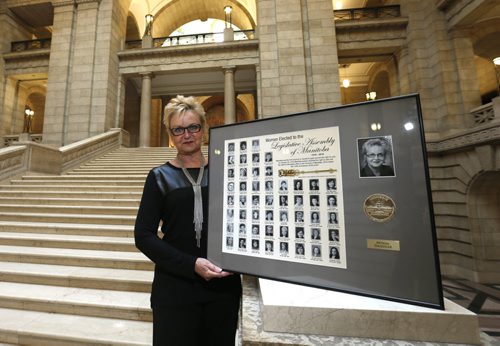 Charleswood MLA Myrna Driedger holds her framed poster showing all 51 female MLAs who ever served in the Manitoba legislature. The photo was taken in the Legislative Building, for story on the centennial of women getting the right to vote. Larry Kusch story Wayne Glowacki / Winnipeg Free Press Jan. 14 2016