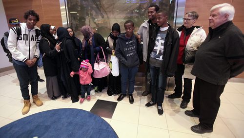 Surviving siblings of the Ismail family pose with Karin GOrdon and Tom Denton of Hospitality House at James Richardson International Thursday evening  after arriving in the city from Saudi Arabia. Their brother Fathi (4th from right) walked across the US/Canadian border in 2014. See Carol Sanders story. January 14, 2016 - (Phil Hossack / Winnipeg Free Press)