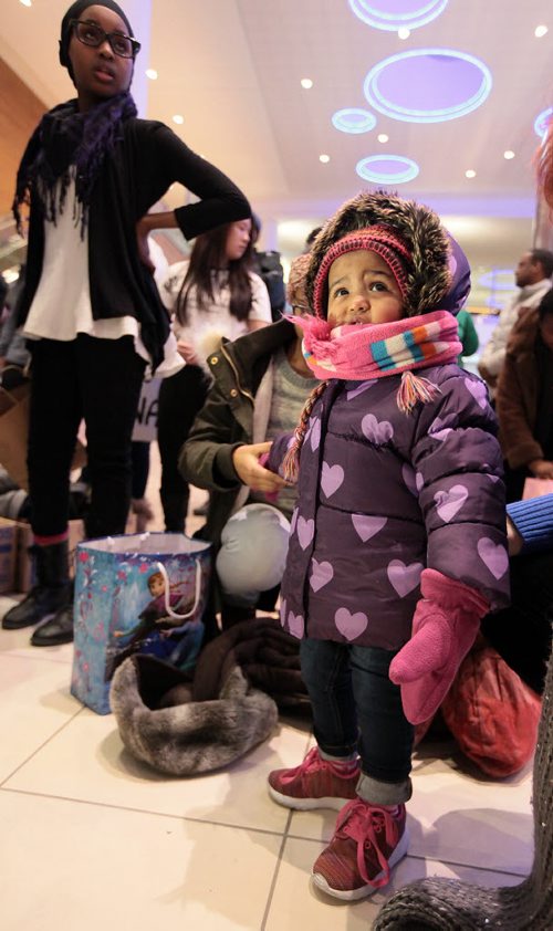 18 mo old Kinda Ismail peers out of a new parka after arriving with her mother and aunts and uncles, all Surviving siblings of the Ismail family who arrived James Richardson International Thursday evening in new parkas in -20C temps after arriving in the city from Saudi Arabia. Their brother Fathi walked across the US/Canadian border in 2014. See Carol Sanders story. January 14, 2016 - (Phil Hossack / Winnipeg Free Press)