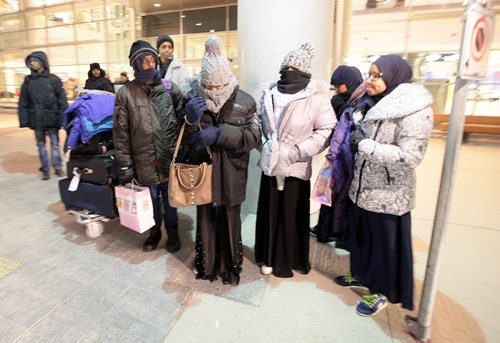 Surviving siblings of the Ismail family wait outside James Richardson International Thursday evening in new parkas in -20C temps after arriving in the city from Saudi Arabia. Their brother Fathi walked across the US/Canadian border in 2014. See Carol Sanders story. January 14, 2016 - (Phil Hossack / Winnipeg Free Press)