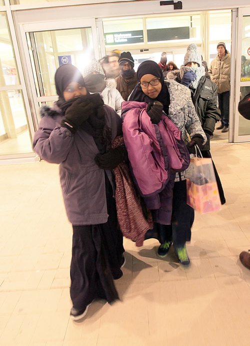 Surviving siblings of the Ismail family walk outside James Richardson International Thursday evening in new parkas in -20C temps after arriving in the city from Saudi Arabia. Their brother Fathi walked across the US/Canadian border in 2014. See Carol Sanders story. January 14, 2016 - (Phil Hossack / Winnipeg Free Press)