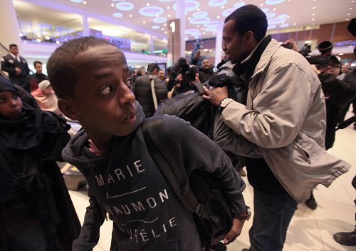 Yasin (9) Ismail reacts to the crush of media and welcoming supporters at James Richardson Airport Thursday as his older brother Fathi (right) greets all of his surviving siblings. Fathi walked across the US/Canadian border in 2014. See Caroll Sanders story. January 14, 2016 - (Phil Hossack / Winnipeg Free Press)