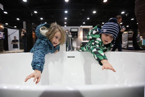 Five-year-old Ellie Chapko and her brother, Luke - 3yrs, check out a large soaker tub at the GreenSlade booth at the Winnipeg Renovation Show Friday afternoon with their grandfather.  The show runs throughout the weekend at RBC Convention Centre.   Standup Jan 15, 2016 Ruth Bonneville / Winnipeg Free Press