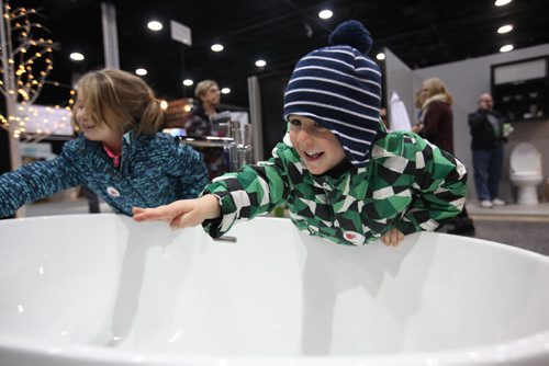 Three-year-old Luke Chapko and his sister, Ellie - 5yrs, check out a large soaker tub at the GreenSlade booth at the Winnipeg Renovation Show Friday afternoon with their grandfather. The show runs throughout the weekend at RBC Convention Centre. Standup Jan 15, 2016 Ruth Bonneville / Winnipeg Free Press