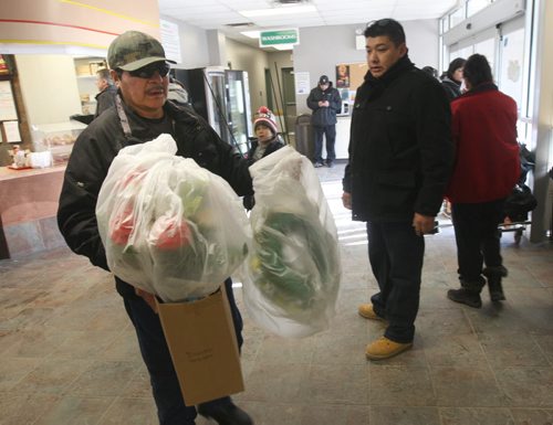 Family Arrives with flowers at Perimeter Airways in Winnipeg Friday  as they prepare to transport three bodies killed in a tragic house fire in Bunibonibee Cree Nation on Jan 29, 2015  -  The bodies were in Winnipeg for autopsies and are making the trip home for burial with the family-See  Alex  Paul Story- Jan 15, 2016   (JOE BRYKSA / WINNIPEG FREE PRESS)