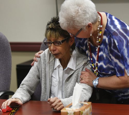 Sue Caribou, the aunt of the two women charged in the citys first homicide of the year is comforted by Karen Harper at a news conference at the AMC offices Friday. She gave an emotional account of the numerous tragedies her family has had to endure.  Alex Paul story  Wayne Glowacki / Winnipeg Free Press Jan. 15 2016