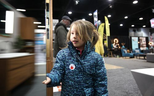 Five-year-old Ellie Chapko checks out a dressing table mirror at the GreenSlade booth at the Winnipeg Renovation Show Friday afternoon with their grandfather.  The show runs throughout the weekend at RBC Convention Centre.   Standup Jan 15, 2016 Ruth Bonneville / Winnipeg Free Press
