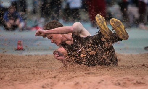 Adam Gundrum is sprayed with sand after his long jump while taking part in the Athletics Manitoba Winter Open Track and Field Meet at the James Daly Fieldhouse, Max Bell Centre, U of Manitoba Saturday.   Jan 16, 2016 Ruth Bonneville / Winnipeg Free Press