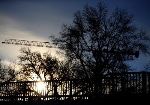 The sun sets behind the Midtown Bridge, Saturday, January 16, 2016. (TREVOR HAGAN/WINNIPEG FREE PRESS)