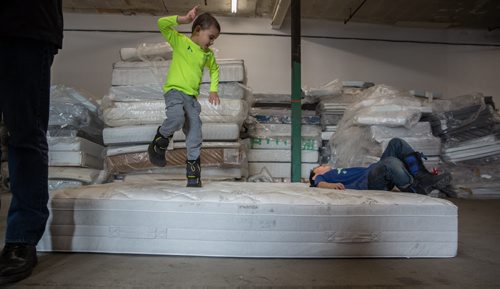 Hayden Chief (left), 5, jumps on an old mattress with Tristan McNabb, 9, while his dad, Manitoba Jobs and Economy Minister, Kevin Chief, is interviewed during the announcement that Mother Earth Recycling has partnered with IKEA to offer an affordable mattress recycling program on Sunday at the new Mother Earth Recycling location at 771 Main Street. If you buy and have your mattress delivered from IKEA you can have the old mattress taken away and recycled for only $10. 160117 - Sunday, January 17, 2016 -  MIKE DEAL / WINNIPEG FREE PRESS