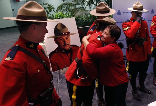 Collette Aubin the first wife  of RCMP Const. Dennis Strongquill who was killed in the line of duty hugs members of the honour guard after the province named a  Manitoba lake after Dennis.  A ceremony was held Monday morning with members of the Strongquill family, Attorney General Gord Mackintosh and Assistant Commissioner Kevin Brosseau at the RCMP D Division HQ . Bill Redekop story. Wayne Glowacki / Winnipeg Free Press Jan. 18 2016