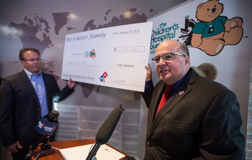 Michael Schlater (right), CEO of Domino's Pizza, helped to open the pizza chain's 400th location at 468 Osbourne Street Monday afternoon as well as donate $2 million to the Children's Hospital Foundation of Manitoba, handing the check to Dr. Mark Evans, Chair of the Children's Hospital Foundation of Manitoba. Domino's Pizza opened it's first international location in Winnipeg in 1983.  160118 - Monday, January 18, 2016 -  MIKE DEAL / WINNIPEG FREE PRESS