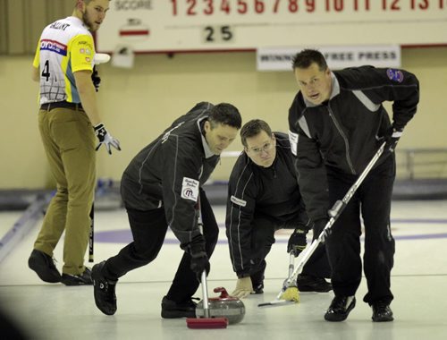 Skip Tory Hamilton steadies himself as sweepers Harder (left) and Kasdorf (sorry no first names available) work the rock toward the rings Monday in the Free Press final at the MCA Open. See Tim Campbell's story.
(Phil Hossack / Winnipeg Free Press)