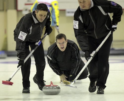 Skip Tory Hamilton roars between sweepers Harder (left) and Kasdorf (sorry no first names available) as they work the rock toward the rings Monday in the Free Press final at the MCA Open. See Tim Campbell's story. (Phil Hossack / Winnipeg Free Press)