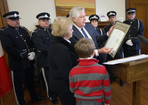 MB Attorney General Gord Mackintosh presents a commemorative picture to young Anthony Commodore( Rhondas son) , and Blanche Commodore (Rhondas mom) during a ceremony honouring his mother Manitoba Corrections  officer Rhonda Commodore ( Anthonys mom) who was killed Nov 06, 2014 in a motor vehicle collision while transporting inmates from the Pas, Manitoba to Dauphin, Manitoba  The Province named a lake 45 km North of Flin Flon, Manitoba in her honour - See  Larry Kusch Story- Jan 19, 2016   (JOE BRYKSA / WINNIPEG FREE PRESS)