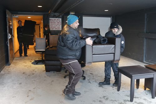 Syrian refugee volunteers and members of the Winnipeg Police Service at the Antares Luxury Suites ( formerly the Place Louis Riel) Tuesday morning move out furniture that is being donated for Syrian refugee families in Winnipeg. The donations that include leather couches and fine furnishings are being loaded onto trucks driven by Hutterite Colonies and taken to a secret location to be sorted and distributed. Bill Redekop/Carol Sanders Wayne Glowacki / Winnipeg Free Press Jan. 19 2016