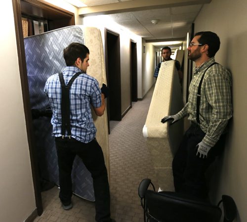 Members of the Crystal Spring Hutterite Colony help out moving beds from rooms at the Antares Luxury Suites ( the formerly the  Place Louis Riel) Tuesday morning, the items are being donated for Syrian refugee families in Winnipeg.  Bill Redekop/Carol Sanders Wayne Glowacki / Winnipeg Free Press Jan. 19 2016