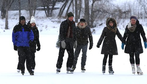 In centre with scarf, Paul Jordan, CEO, The Forks Renewal Corporation with fellow skaters on the Red River Mutual Trail after it officially opened Thursday morning. This section of the trail begins at the skating rink on the Assiniboine River at The Forks and ends at the Norwood Bridge. Bill Redekop story. Wayne Glowacki / Winnipeg Free Press Jan. 21 2016
