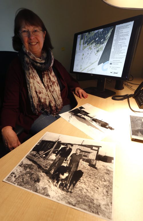 49.8 - Rooster Town. Evelyn Peters, a U of W prof. who's spent last few years researching Rooster Town and its inhabitants, who were mostly Metis and immigrant squatters living in shanties for decades. They were displaced in late 50s to make way for Grant Park shopping mall. She is with photos of  Rooster Town taken in 1950's, in the foreground is a photo Ernest and Elizabeth Stocks by their home. Randy Turner story Wayne Glowacki / Winnipeg Free Press Jan. 22 2016