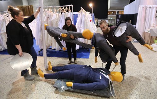 Lauren Ridd, Christine Zakaluk, and Brett Kuchciak from Eph Apparel moving mannequins across the Winnipeg Wedding Show at the Winnipeg Convention Centre, Friday, January 22, 2016. (TREVOR HAGAN / WINNIPEG FREE PRESS)