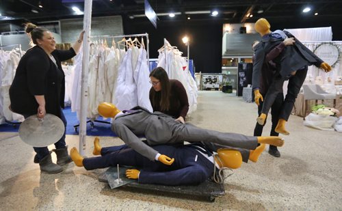 Lauren Ridd, Christine Zakaluk, and Brett Kuchciak from Eph Apparel moving mannequins across the Winnipeg Wedding Show at the Winnipeg Convention Centre, Friday, January 22, 2016. (TREVOR HAGAN / WINNIPEG FREE PRESS)