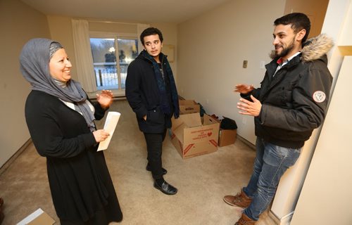 Nadia Ourrhi, life skills councillor from Welcome Place, mentoring Abdul Absuleh, as they assist new refugee Ahmed Mohmoud, Friday, January 22, 2016. (TREVOR HAGAN/WINNIPEG FREE PRESS)