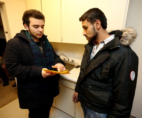 Abdul Absuleh, life skills councillor from Welcome Place, with new refugee Ahmed Mohmoud, Friday, January 22, 2016. (TREVOR HAGAN/WINNIPEG FREE PRESS)